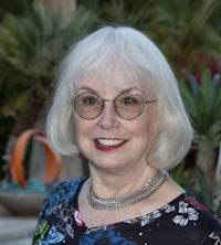 an older woman wearing glasses and a floral top